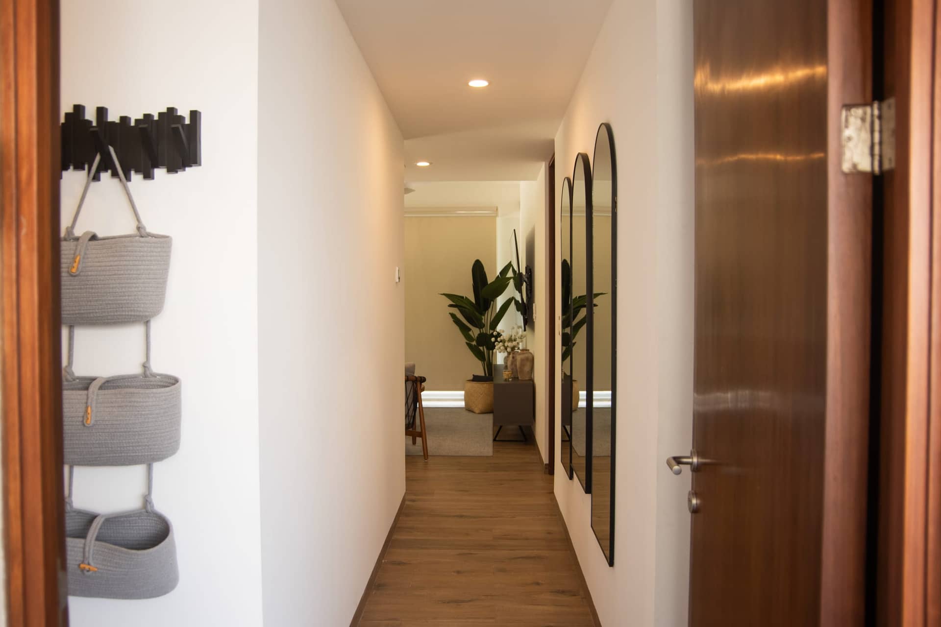 Modern hallway with arched mirrors at The Leaf Playacar