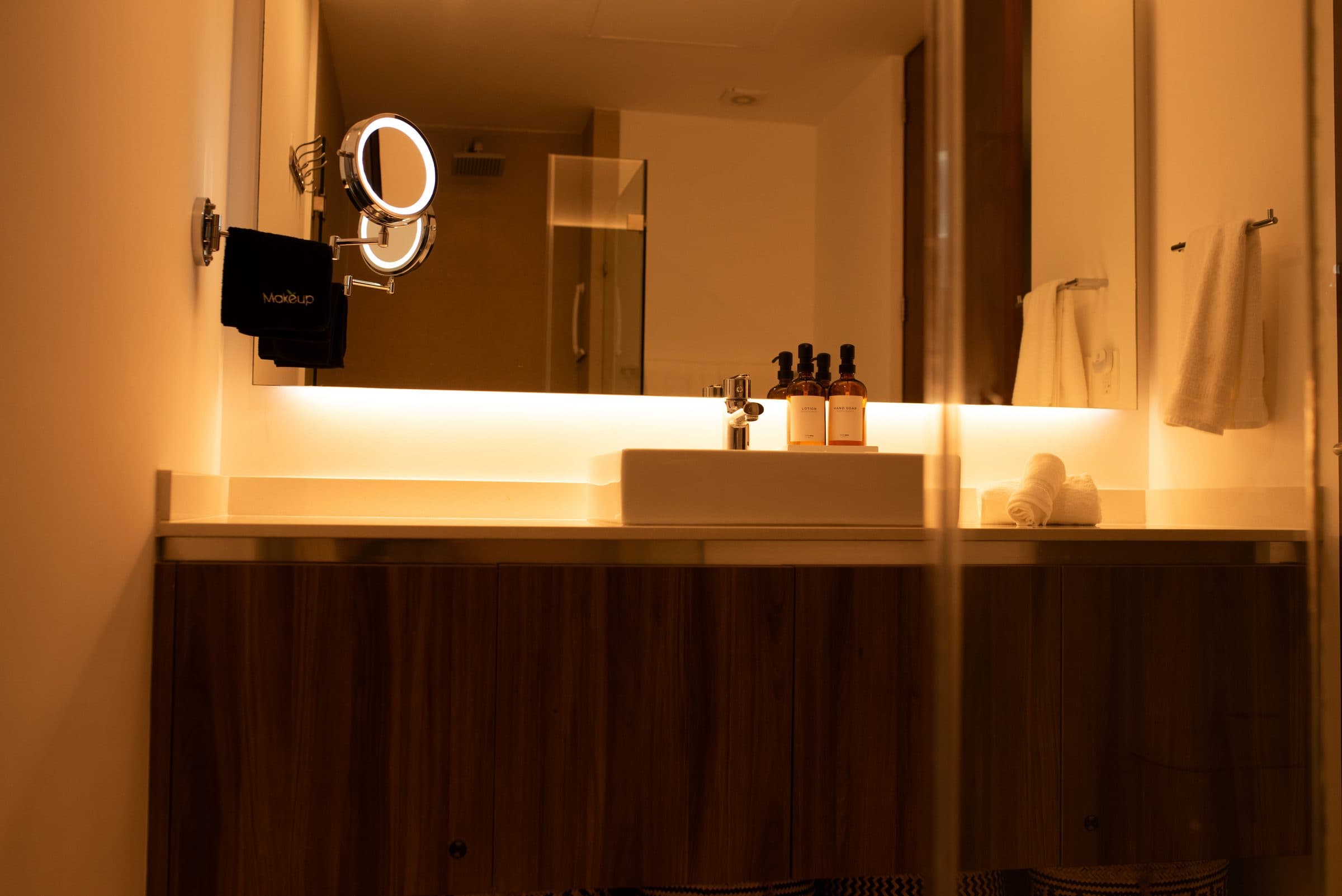 Luxury spa bathroom vanity with backlit mirror and designer toiletries at The Leaf Playacar