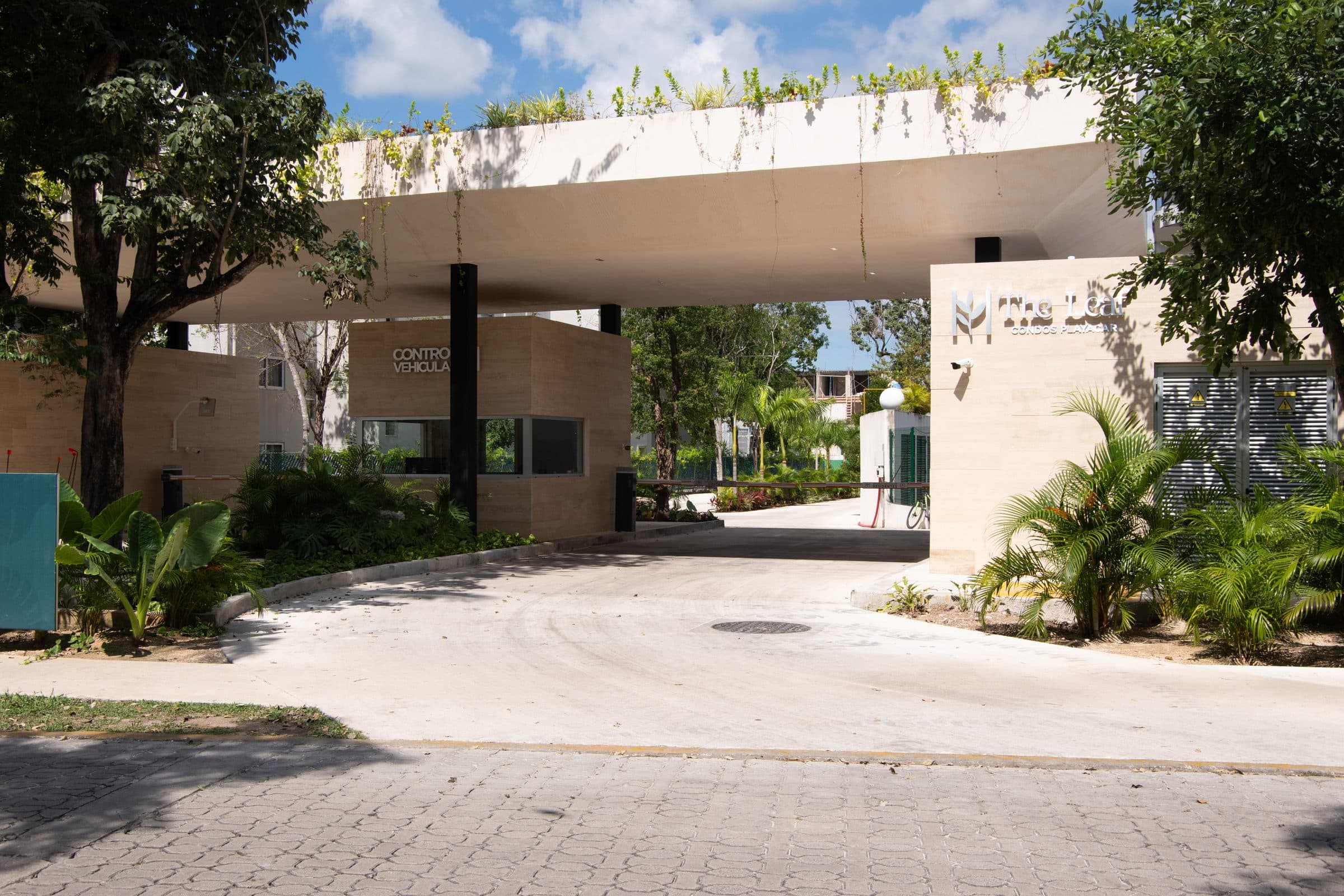 The Leaf Playacar gated entrance with tropical landscaping