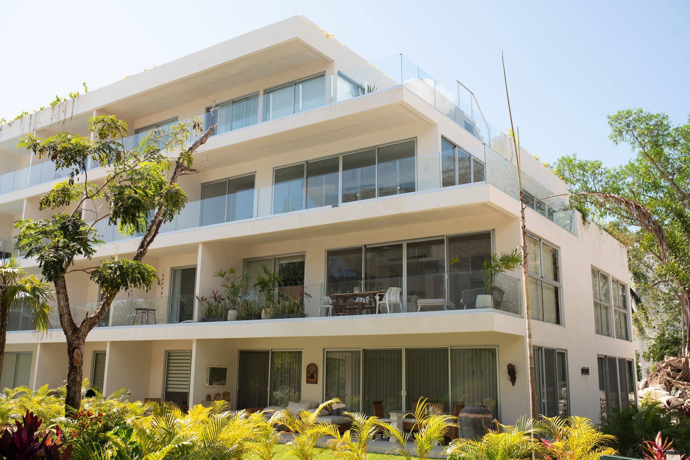 The Leaf Playacar modern white villa exterior with glass balconies